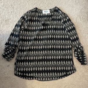 Black with tan pattern 3/4 sleeve blouse with button detail on shoulder. Size L.